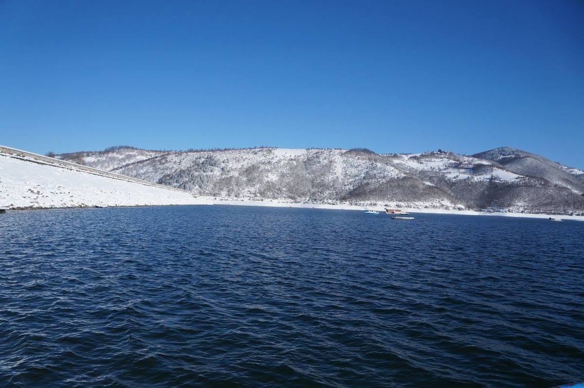 Zlatarsko jezero okruzeno snežnim brdima 